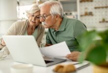Senior couple analyzing their savings while going through home f