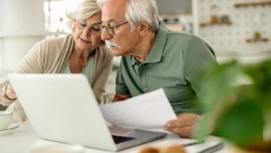 Senior couple analyzing their savings while going through home f