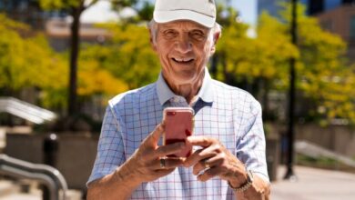 senior man using smartphone while walk outdoors 23 2150579710