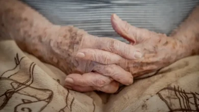 Mãos envelhecidas de um idoso com as unhas bem cuidadas, representando o público-alvo das isenções para maiores de 60 anos.