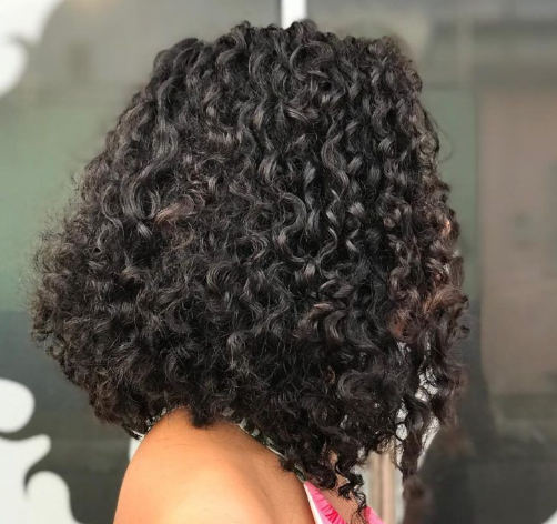 Imagem de uma mulher usando um corte de cabelo long bob cacheado