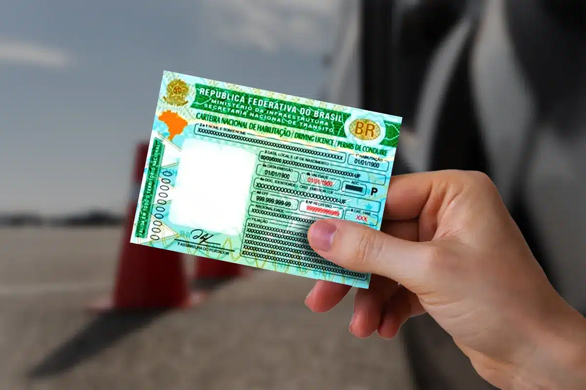 Pessoa segurando uma Carteira Nacional de Habilitação (CNH) com fundo desfocado.