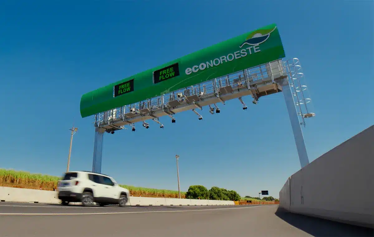 Placa de pedágio Free Flow em rodovia, indicando pagamento eletrônico sem necessidade de parar