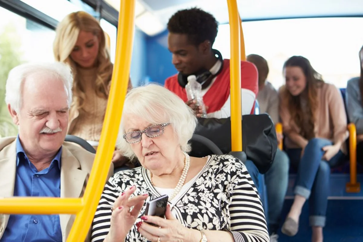 Idosos e jovens compartilhando um transporte público, representando a gratuidade para pessoas da terceira idade.