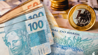 Dinheiro brasileiro em cédulas e moedas, representando benefícios previdenciários.