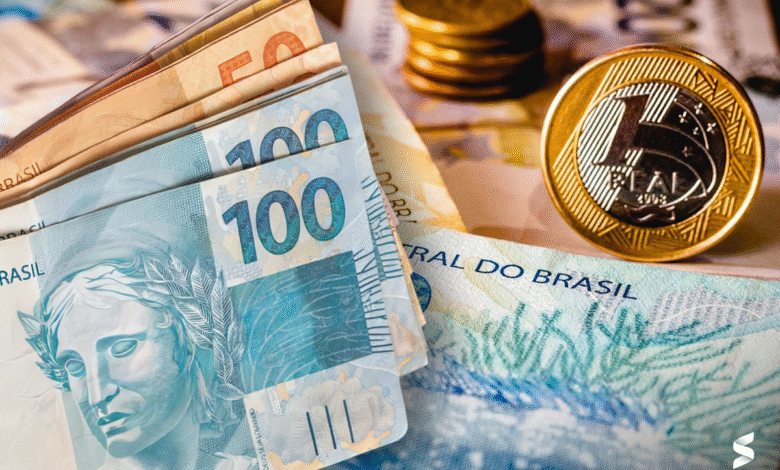Dinheiro brasileiro em cédulas e moedas, representando benefícios previdenciários.