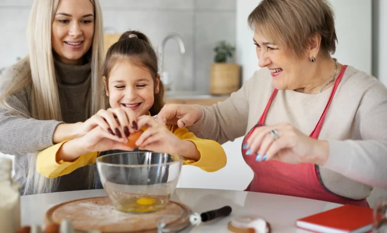 Criança, mãe e avó preparando uma receita juntas na cozinha, representando um momento especial para o Dia das Mães.