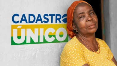 Idosa sorridente com lenço laranja e blusa amarela ao lado do logo do Cadastro Único
