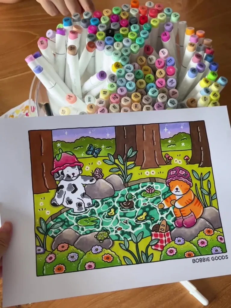 Desenho colorido de cena na floresta ao lado de um conjunto de marcadores coloridos