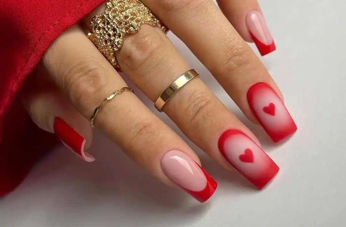 Unhas românticas com decoração em vermelho e detalhes de corações, perfeitas para o Dia dos Namorados.