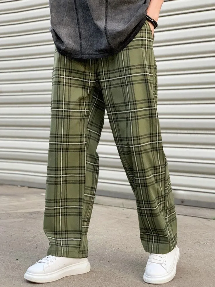 Homem usando calça xadrez verde com tênis branco, em um estilo casual.