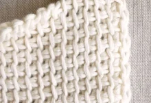Detalhe de um crochê com ponto básico, mostrando fios e agulha. Ideal para iniciantes.