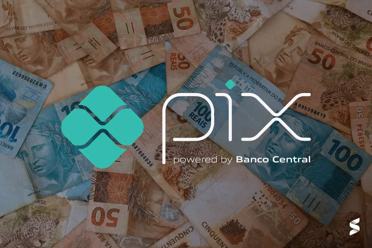 Logo do Pix sobre notas de dinheiro brasileiras, representando o pagamento rápido e eficiente.