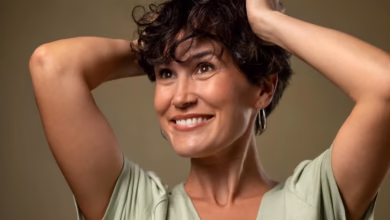 Mulher madura sorrindo após corte de cabelo moderno, destacando um estilo rejuvenescente e elegante.