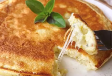 Pão de queijo de frigideira com queijo derretido e superfície dourada