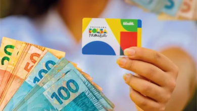 Cartão do Bolsa Família com cédulas de dinheiro, representando o pagamento do benefício em agosto de 2025."