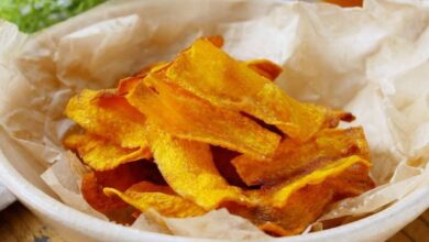 Chips crocantes de cenoura (ou batata-doce) em uma tigela, um exemplo de petisco delicioso e simples feito a partir do reaproveitamento criativo de sobras de vegetais.