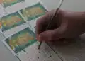 Pessoa marcando os números na Mega da Virada 2025, aposta para o prêmio de R$ 1 bilhão.