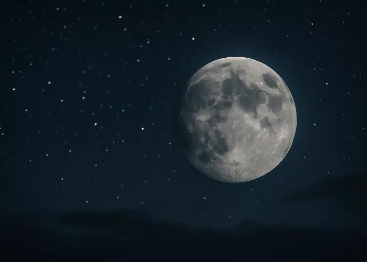 Lua cheia brilhando em céu escuro repleto de estrelas, transmite calma e serenidade
